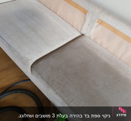 ספה עם כתמים, צינור שואב ובקבוק ניקוי ירוק